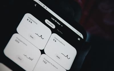Black smartphone showing white medication pill