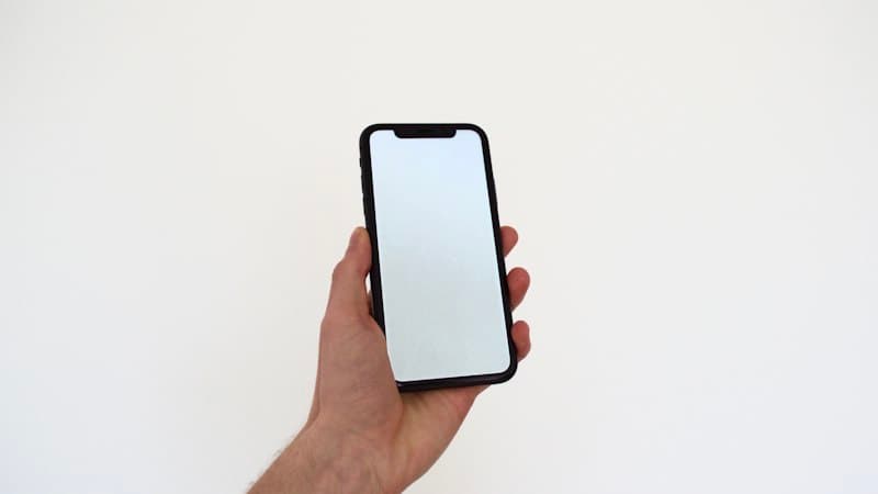 iPhone with iOS 18 showing TikTok video download process in Safari