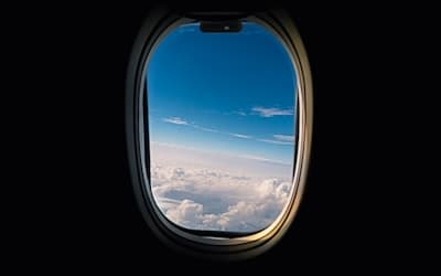 Airline window viewing white clouds