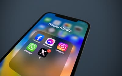 A close up of a cell phone with social media icons