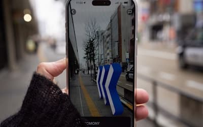 A person taking a picture of a street with their cell phone