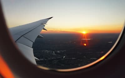 Airplanes window view of sky during golden hour