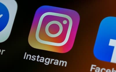 The Instagram app icon on a smartphone screen with other app icons