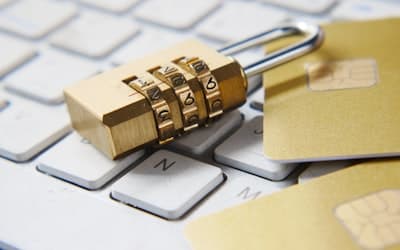 A golden padlock sitting on top of a keyboard