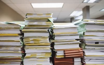 Stacks of paper documents and file folders