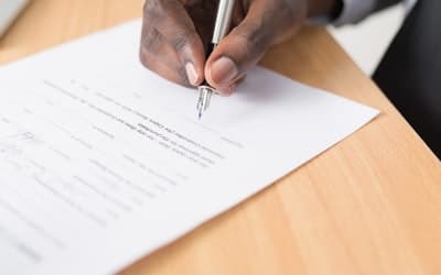Person writing on white paper