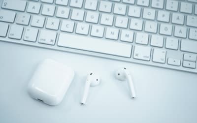 Apple earpods on white computer keyboard