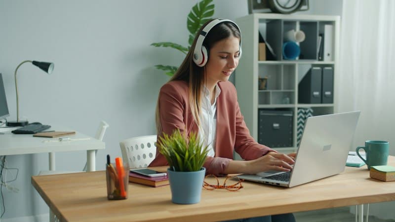 Headphones next to a phone showing TikTok trending sounds
