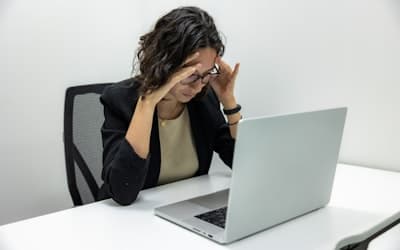 A woman sitting in front of a laptop computer